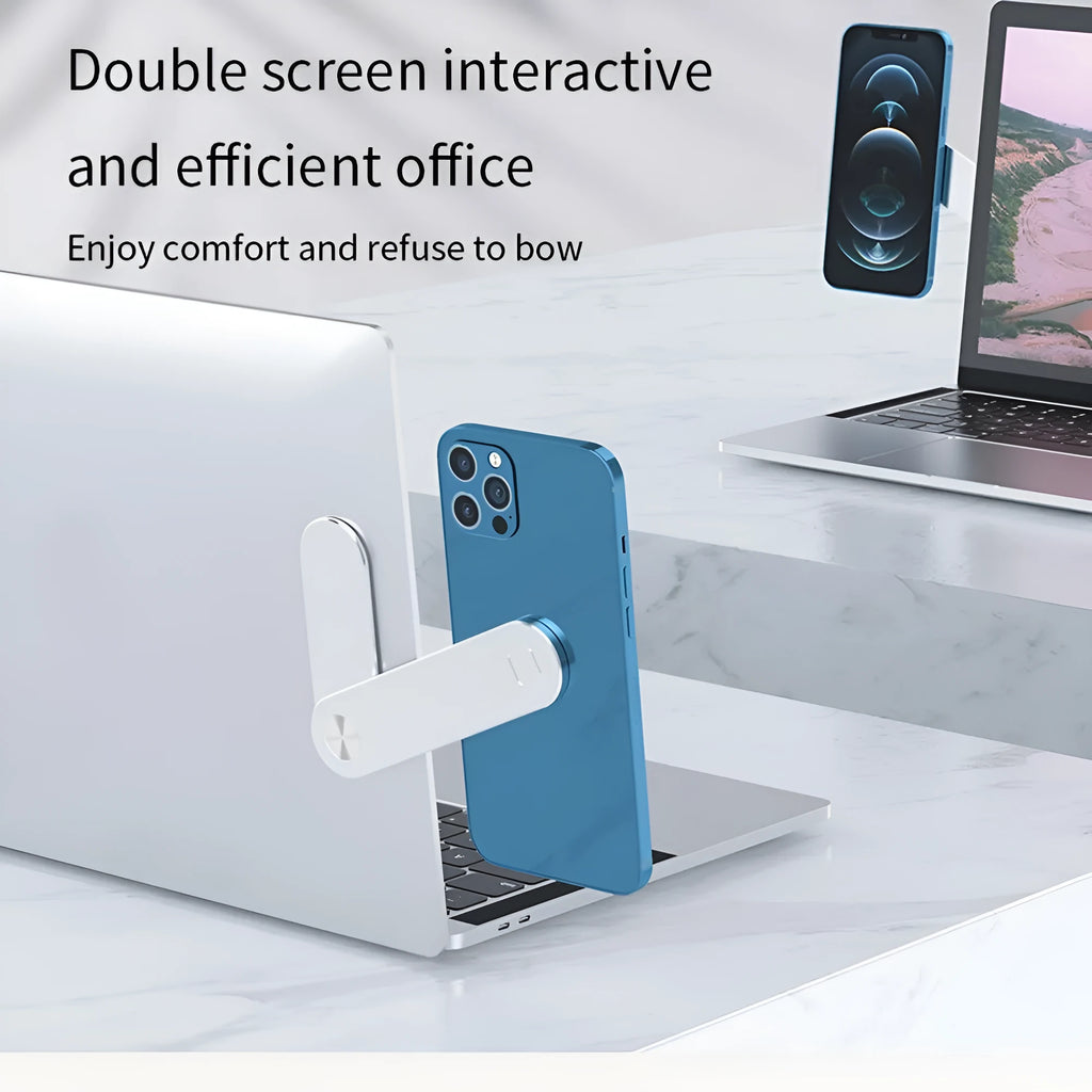 Black magnetic phone holder attached to side of silver laptop, showing phone mounted.