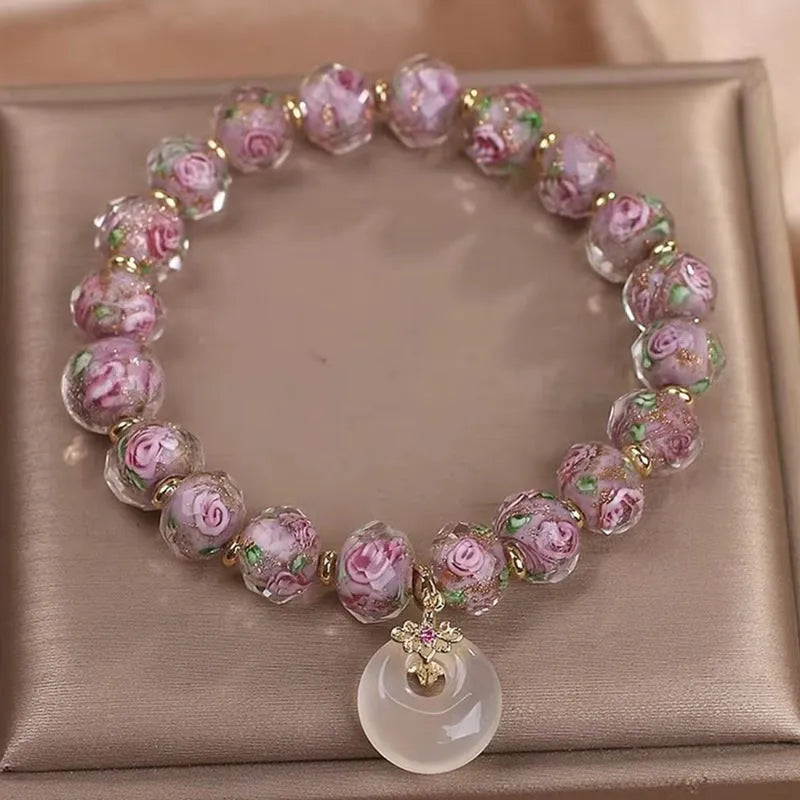 Purple glass flower amethyst bracelet with peace buckle on white background