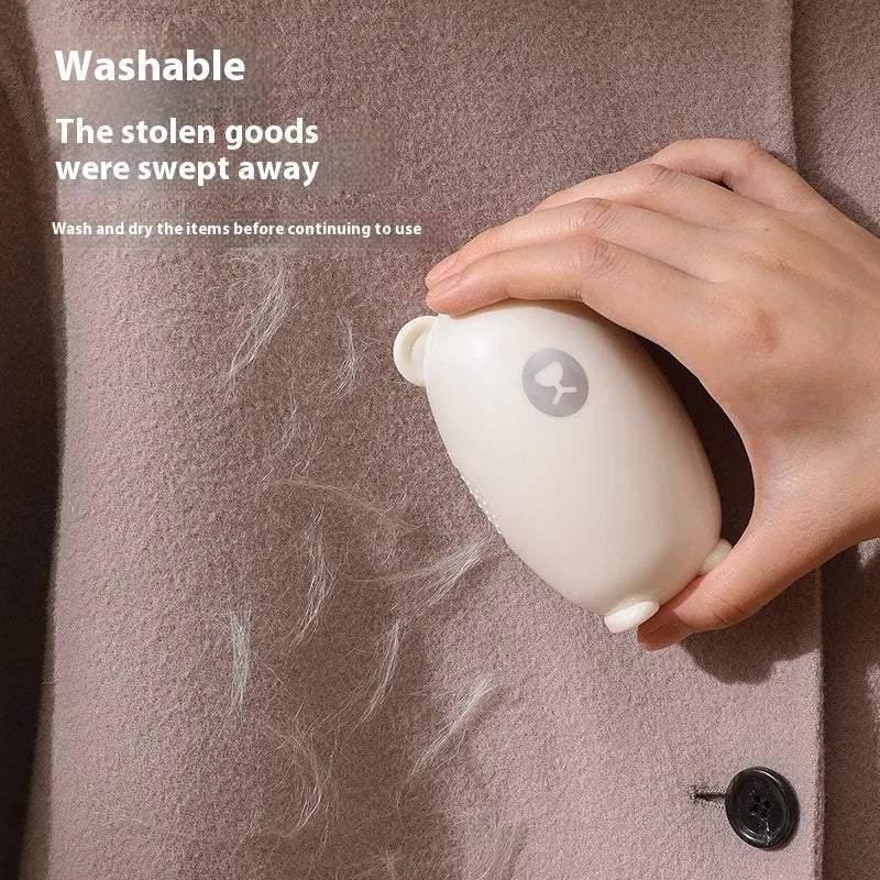 Washable silicone lint removal roller in green, pink, or white colours on fabric surface