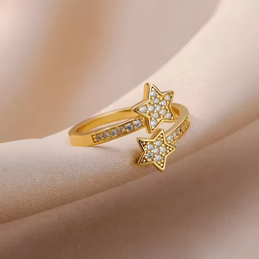 Gold cold style zircon star open-end ring and bracelet set on white background