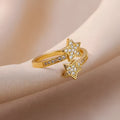 Gold cold style zircon star open-end ring and bracelet set on white background