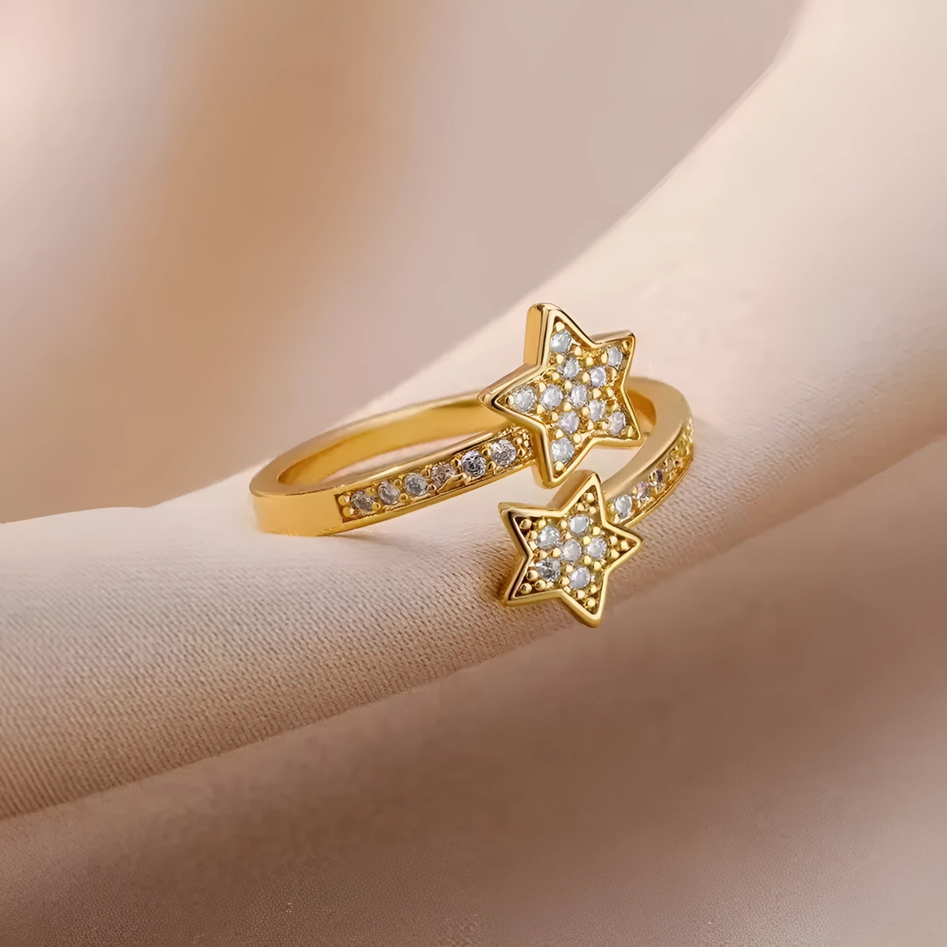 Gold cold style zircon star open-end ring and bracelet set on white background