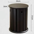 Stackable round iron dining stool in smoked black, walnut, cherrywood, or cream colour on a tiled floor.