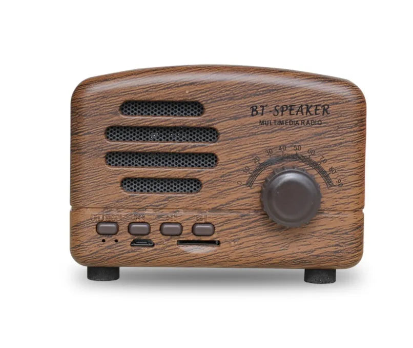 Vintage-style wood grain finish Bluetooth speaker on a table, showing compact size and USB port.