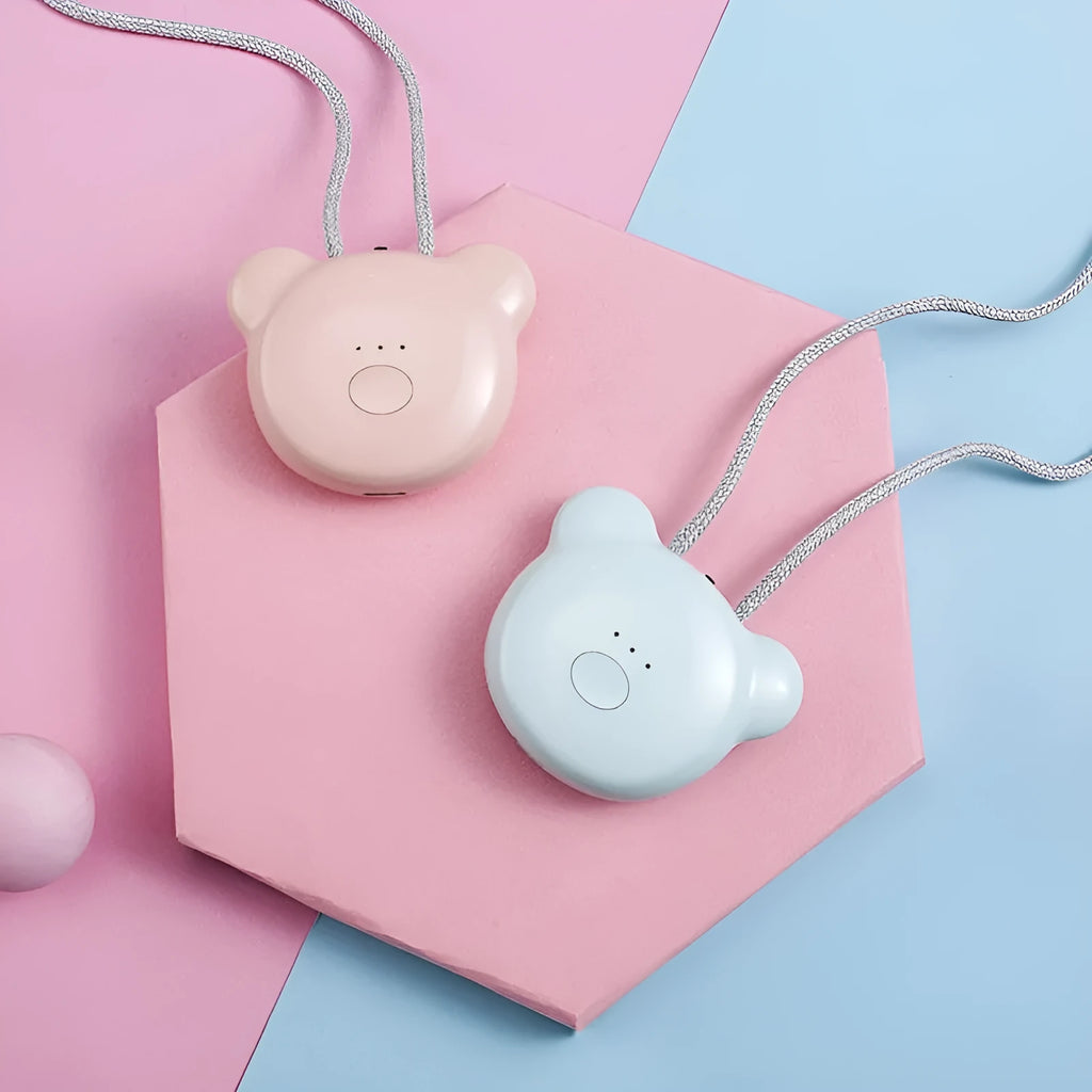 Mini USB portable air purifier necklace in pink, showing compact size and wearable design.