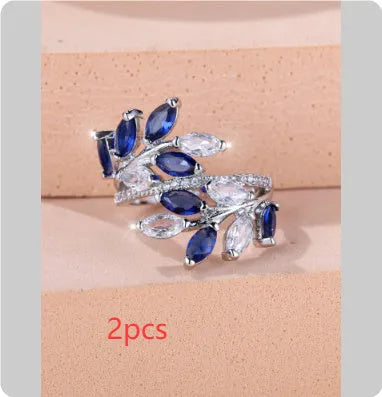 Adjustable copper leaf-shaped ring with a central horse eye zircon stone, shown in a rose gold finish.