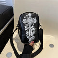 Black Halloween graffiti crossbody bag with cartoon pumpkin, ghost, and bat print, shown with adjustable strap.