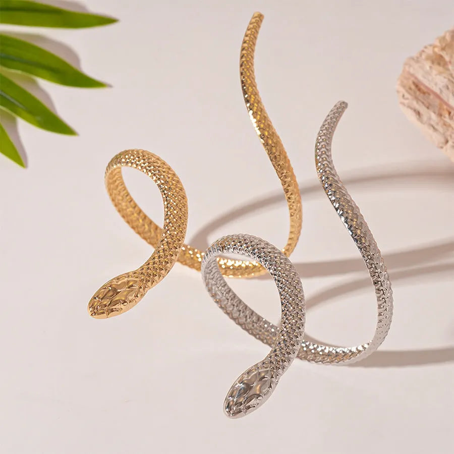 Gold metal snake-inspired ring and bracelet set with exaggerated twisted winding design