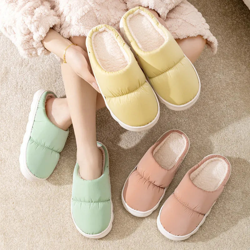 Blue down cotton winter slippers with thick rubber sole and plush lining for indoor use.