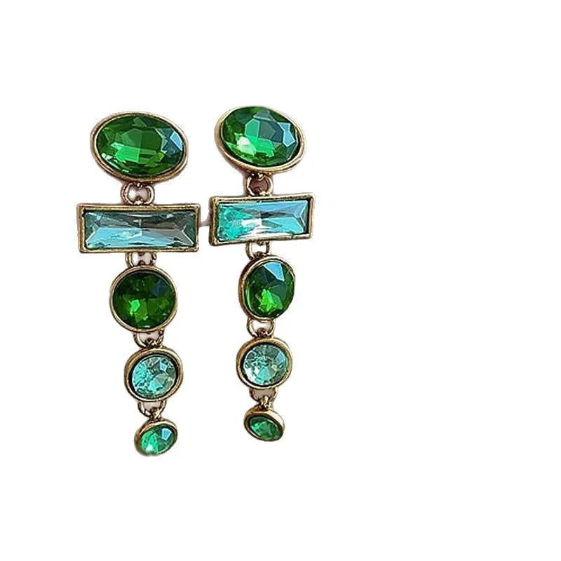 Green gradient geometric alloy earrings with a long tassel and sparkling inlaid zircon centre on a white background.
