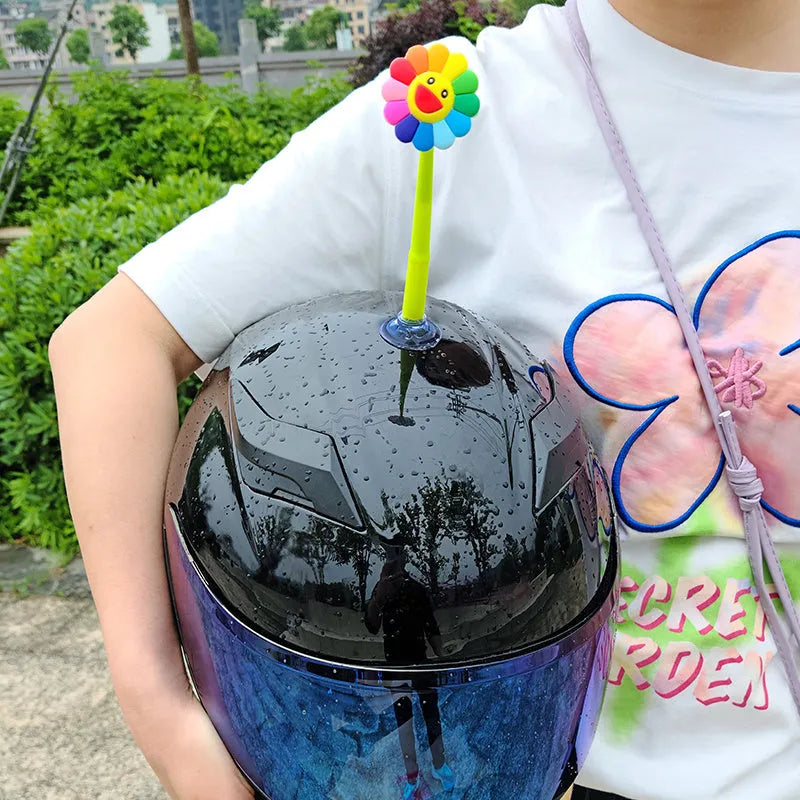 Yellow silicone swinging sunflower decoration with suction cup for helmet attachment.