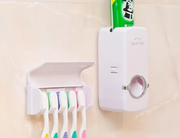 White adhesive plastic toothbrush holder set mounted on a smooth bathroom wall
