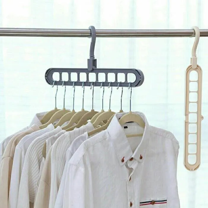 Plastic clothes hanger with rotating hook in pink colour, shown next to a green hanger.