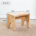 Distressed solid wood shoe changing stool with rustic bracket structure.