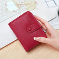 A compact beige ladies' short wallet with a textured lychee pattern, shown folded.