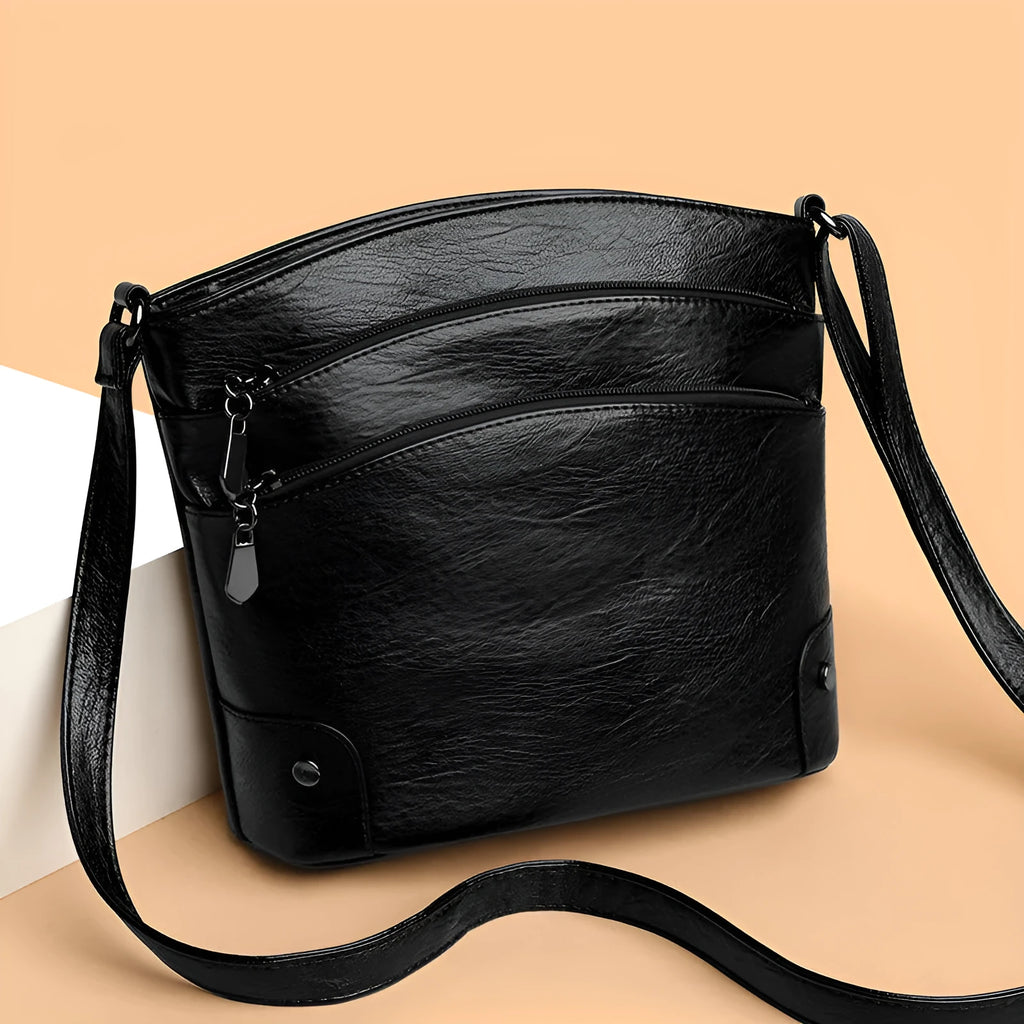Large capacity PU bucket bag for women in black with multi-layer internal pockets and outer slit pocket