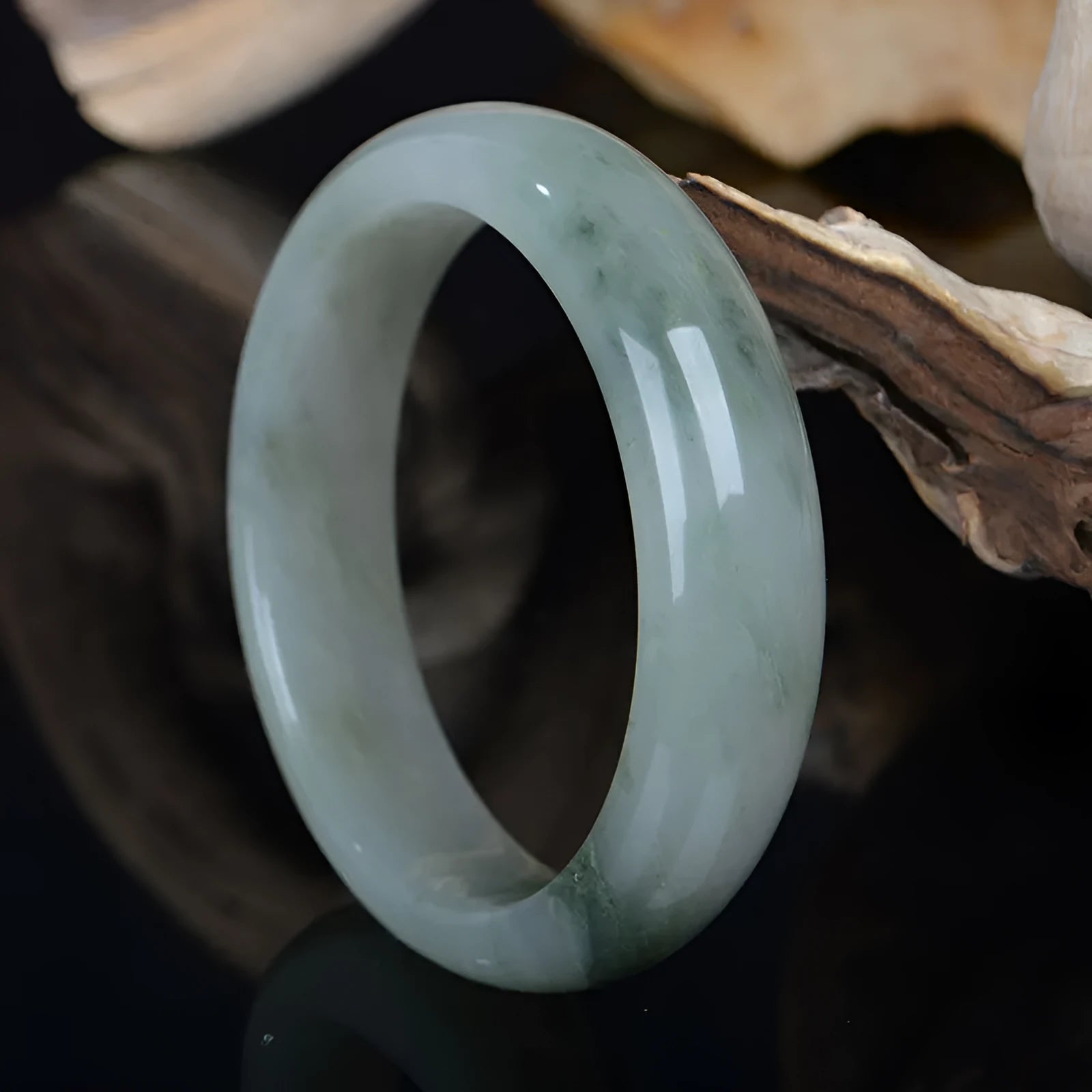 Natural Jinsi Jade Chinese style bracelet in a bangle shape on a plain background.