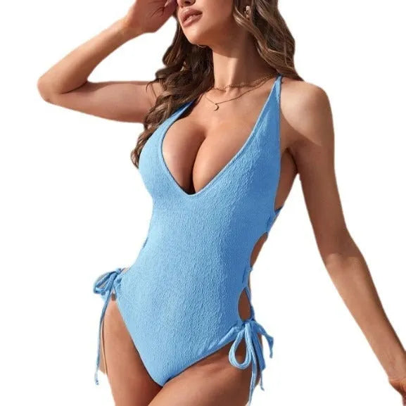 Women's black one-piece swimsuit with a hollow backless design and a central tether strap.