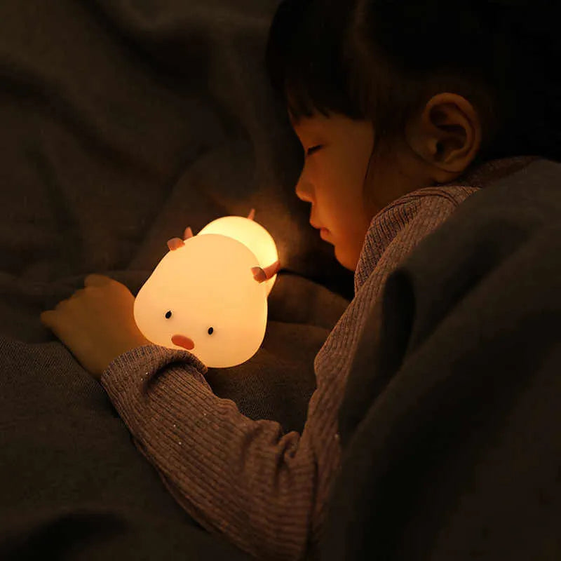 Blue or pink pig silicone night light with sleeping design, shown with dimensions and rechargeable battery.