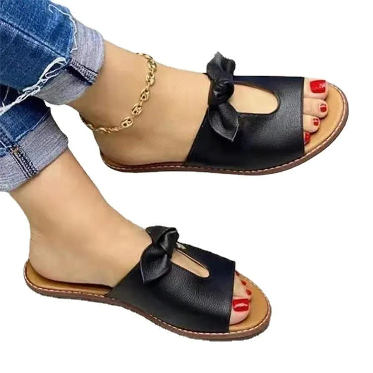 Ladies casual sandals with bow detailing on fish mouth slipper style in black, pink or gold colours