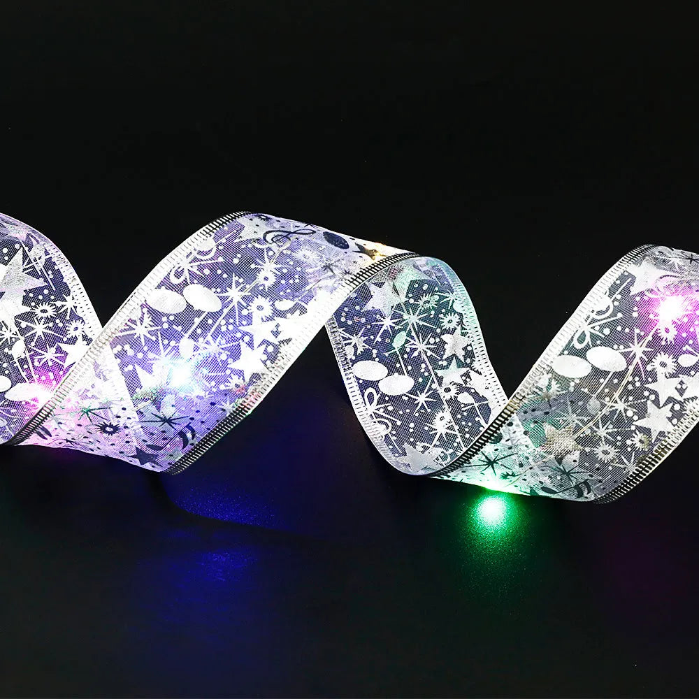 Christmas fairy light string with cloth ribbon bow tie decoration in gold or silver colours.