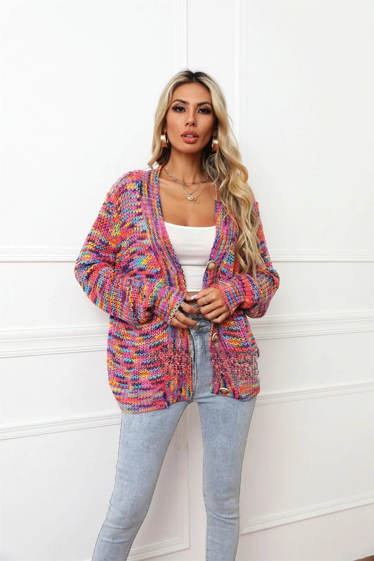 Rose red loose fit short cardigan coat with rainbow striped pattern on a hanger.