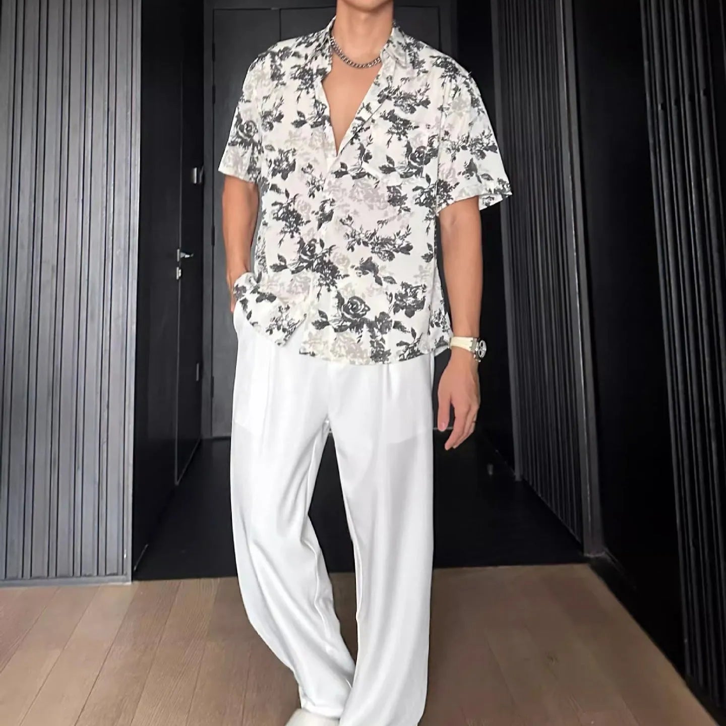 Loose fit floral printed short sleeve shirt in black, hanging on a hanger.