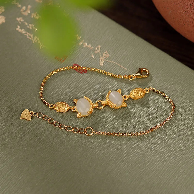 Close-up of a women's silver bracelet with a detailed retro fox charm on an adjustable chain.