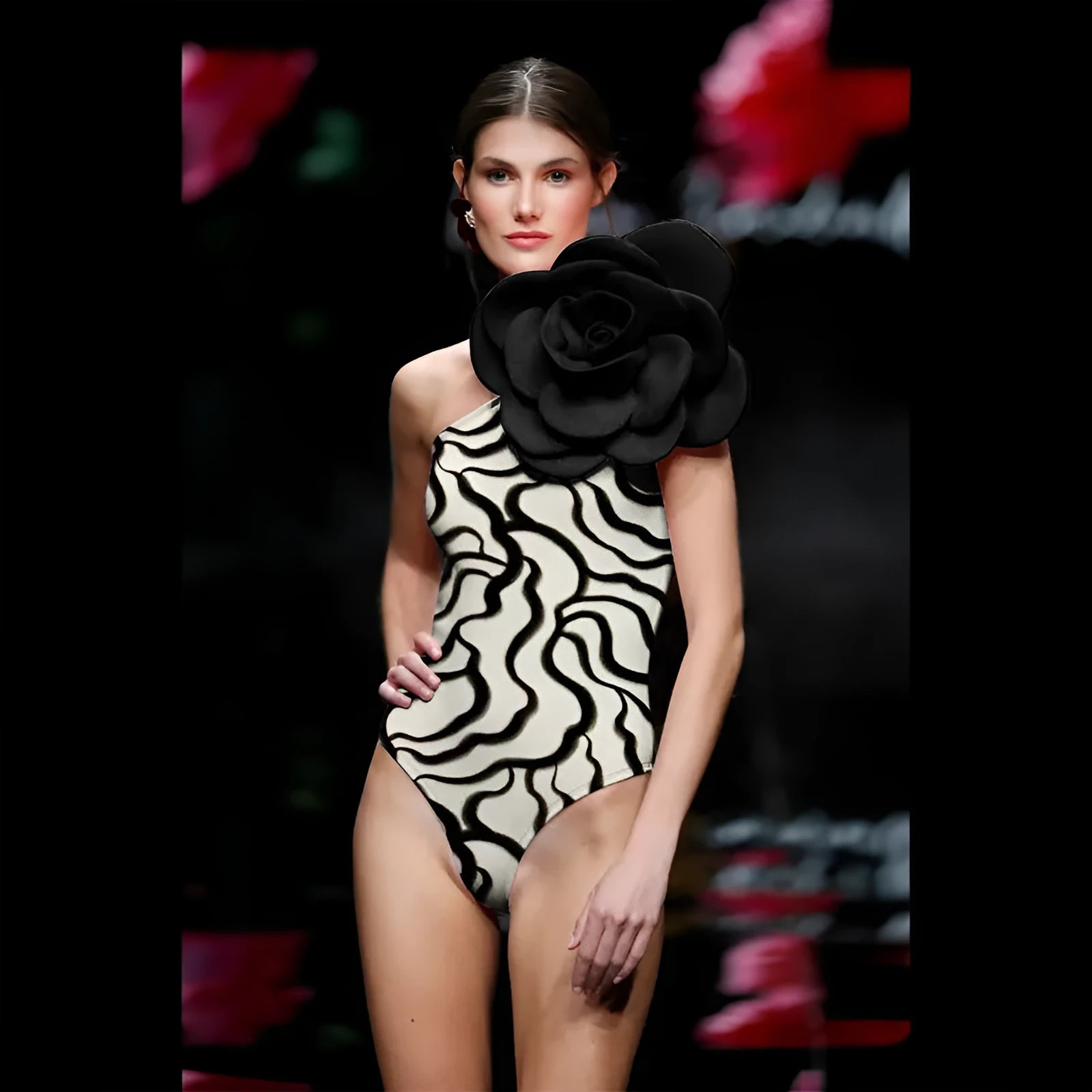 One-piece swimsuit with three-dimensional floral detail in solid colours, sized S to XL.