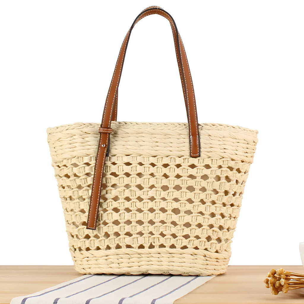 Beige horizontal square woven paper-string shoulder bag showing wide opening and adjustable strap