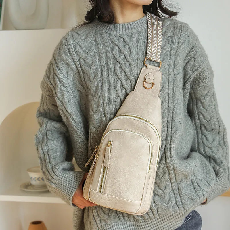 Soft brown women's crossbody messenger bag with an outer open pocket and adjustable strap.