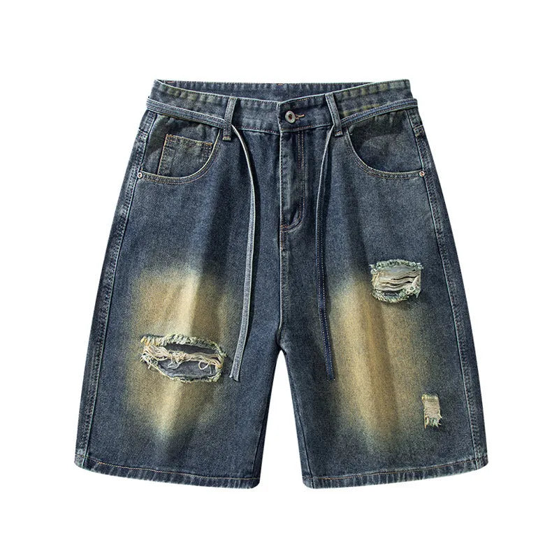 Loose-fit ripped jeans in retro blue denim, shown on a model, highlighting the baggy fit and distressed details.