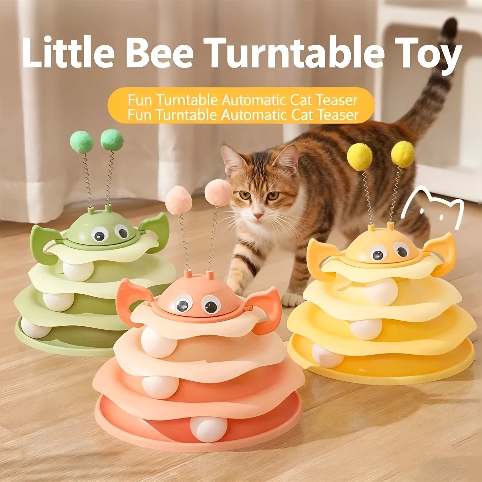 Cat toy tower with rotating bee toy and three-layer trackball in green plastic, placed on a wooden floor