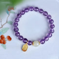 Close-up of a women's amethyst bracelet with 8mm geometric crystal beads on a wrist.