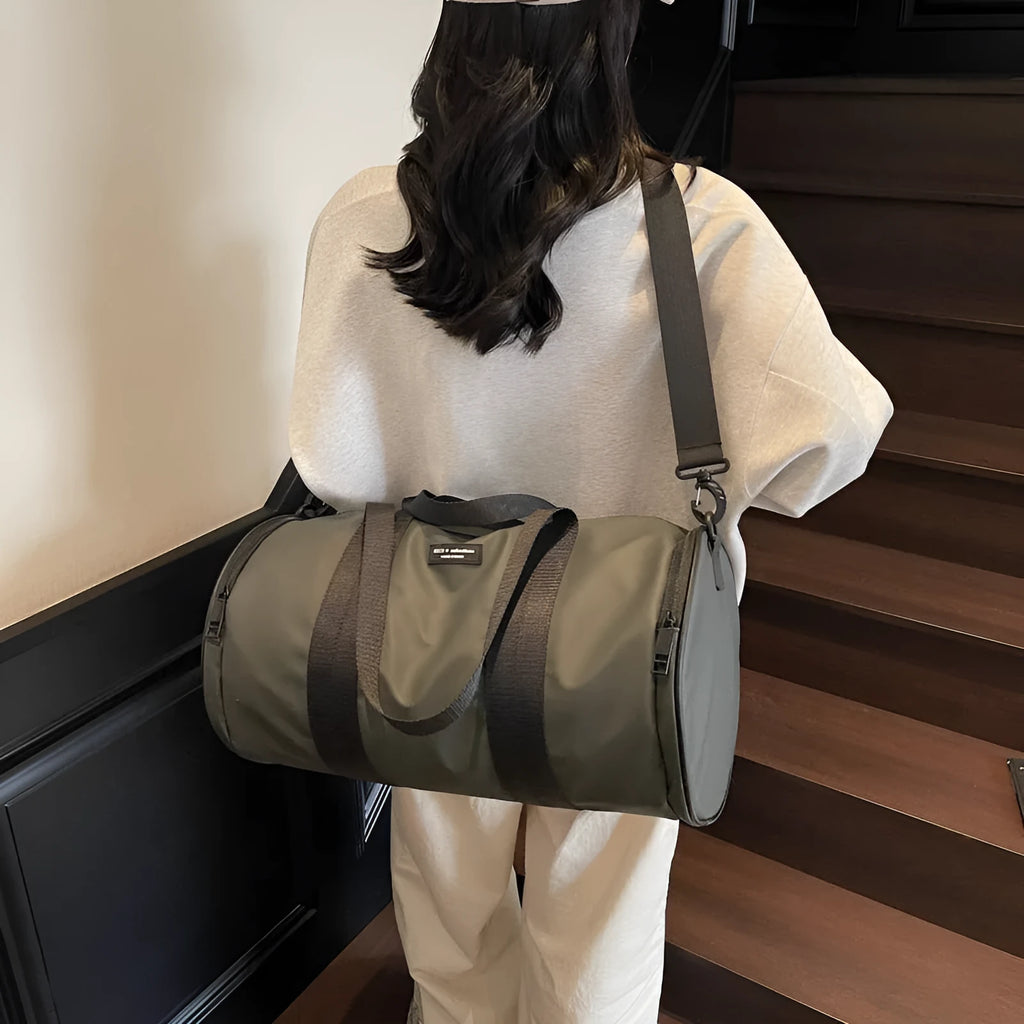 Black waterproof Oxford cloth sports handbag for men and women on a leisure travel background.