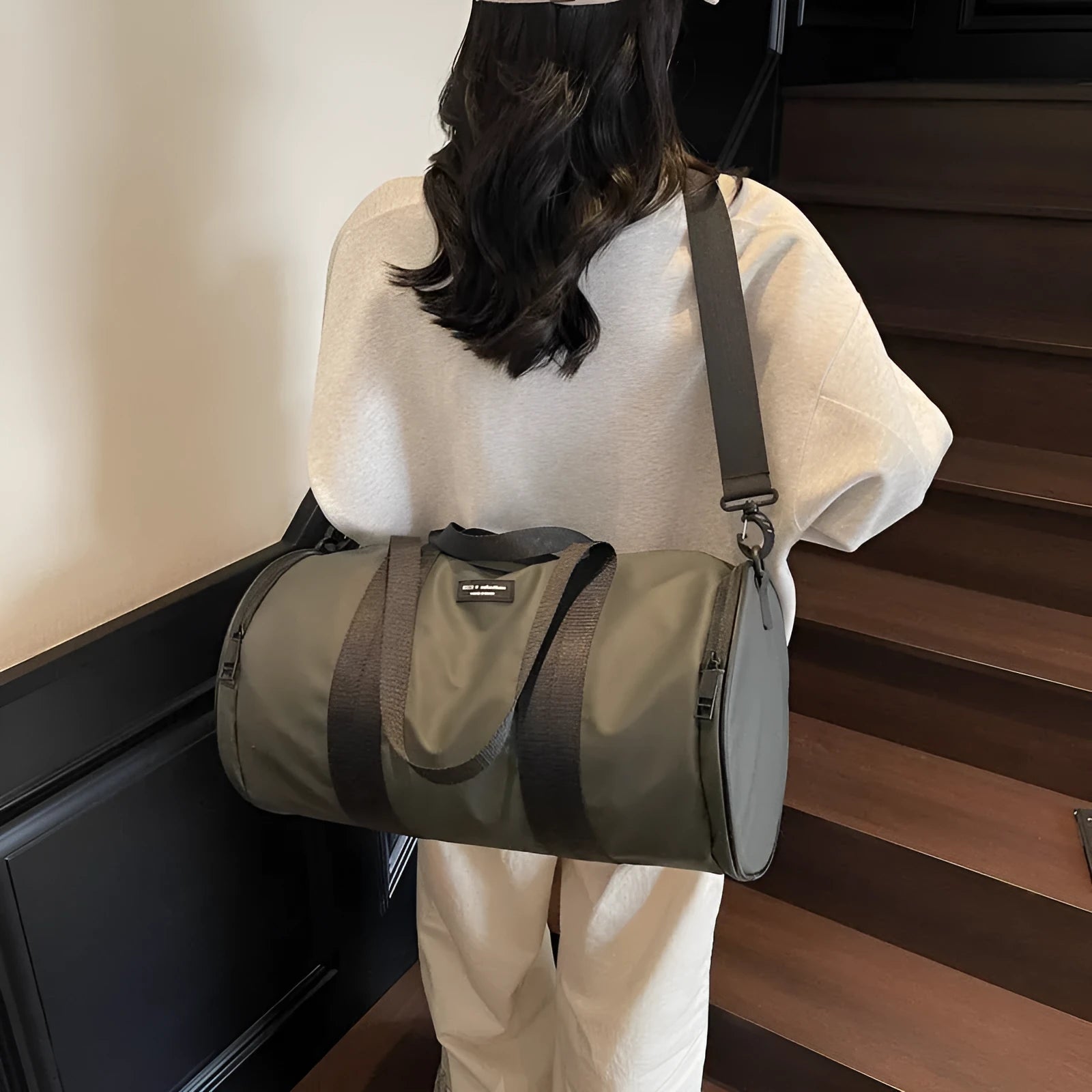 Black waterproof Oxford cloth sports handbag for men and women on a leisure travel background.