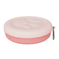 Collapsible silicone dog bowl in light pink, shown both folded flat and popped open, with separate lid next to it.