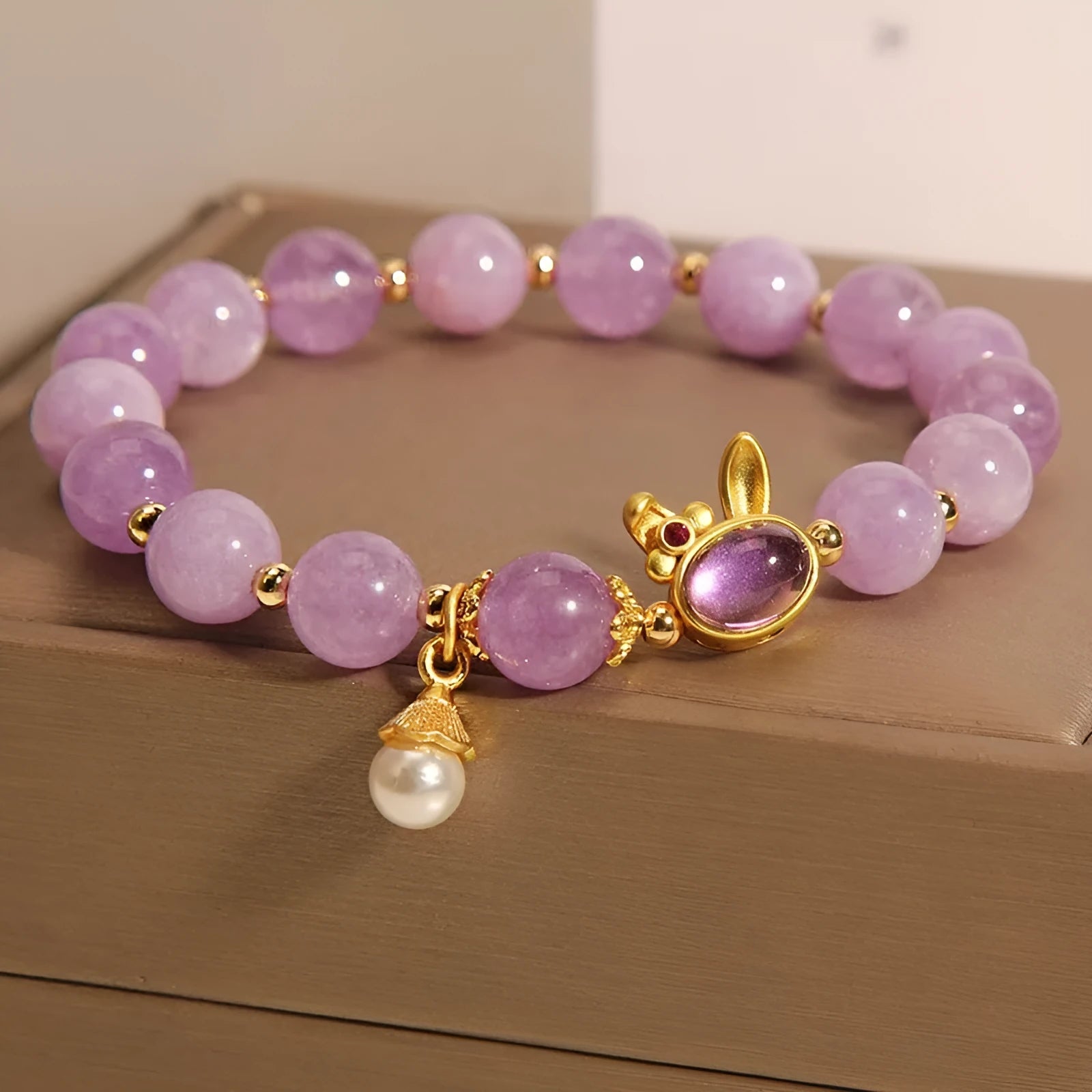 Mauve jade rabbit bracelet with crystal hare head design on adjustable wristband