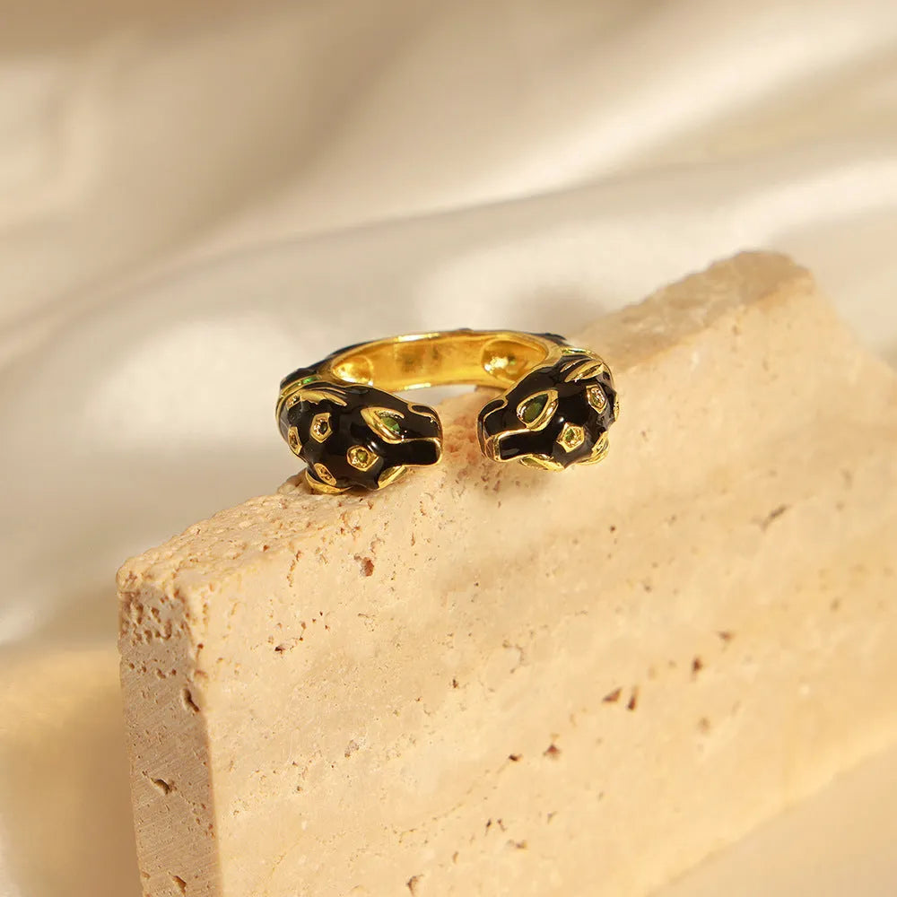 Geometric open ring with black cheetah oil drip print, size 7, on a copper band.