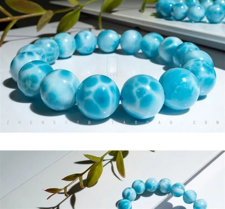 Blue bodhi bracelet with natural sea-pattern crystal stones and a single pearl bead.