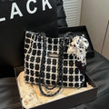Black woven wool shoulder bag with horizontal square design and internal organisation compartments