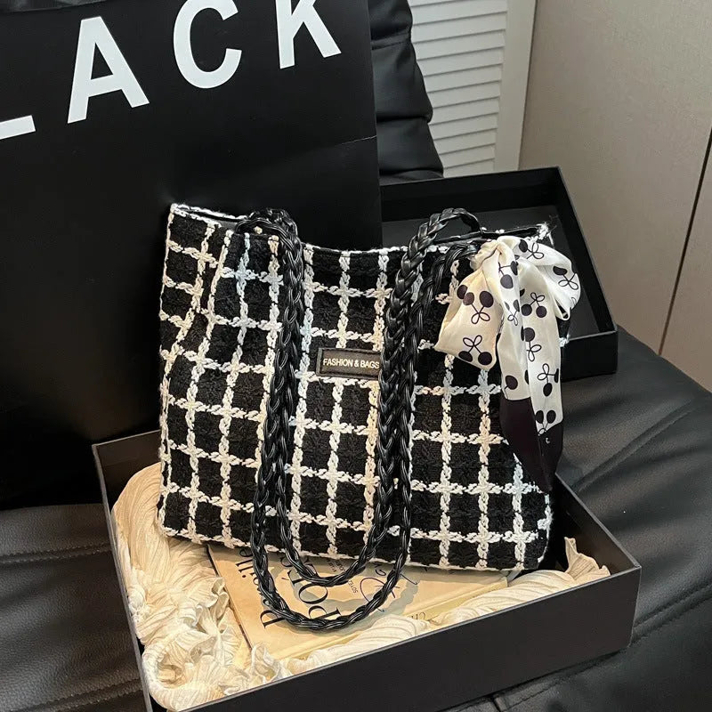Black woven wool shoulder bag with horizontal square design and internal organisation compartments