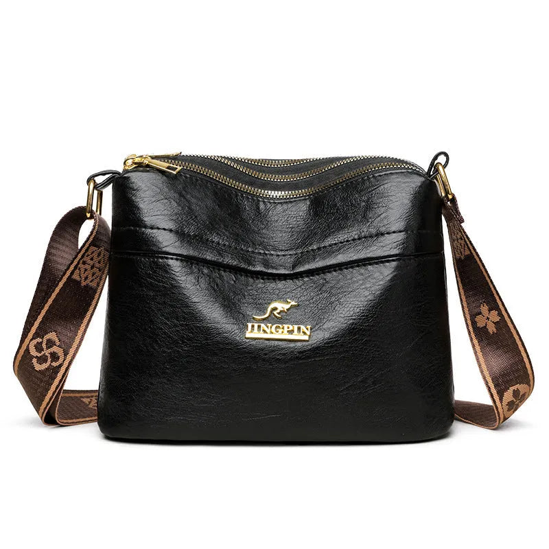 Brown cross body messenger bag with multiple compartments and sewing thread details on PU material