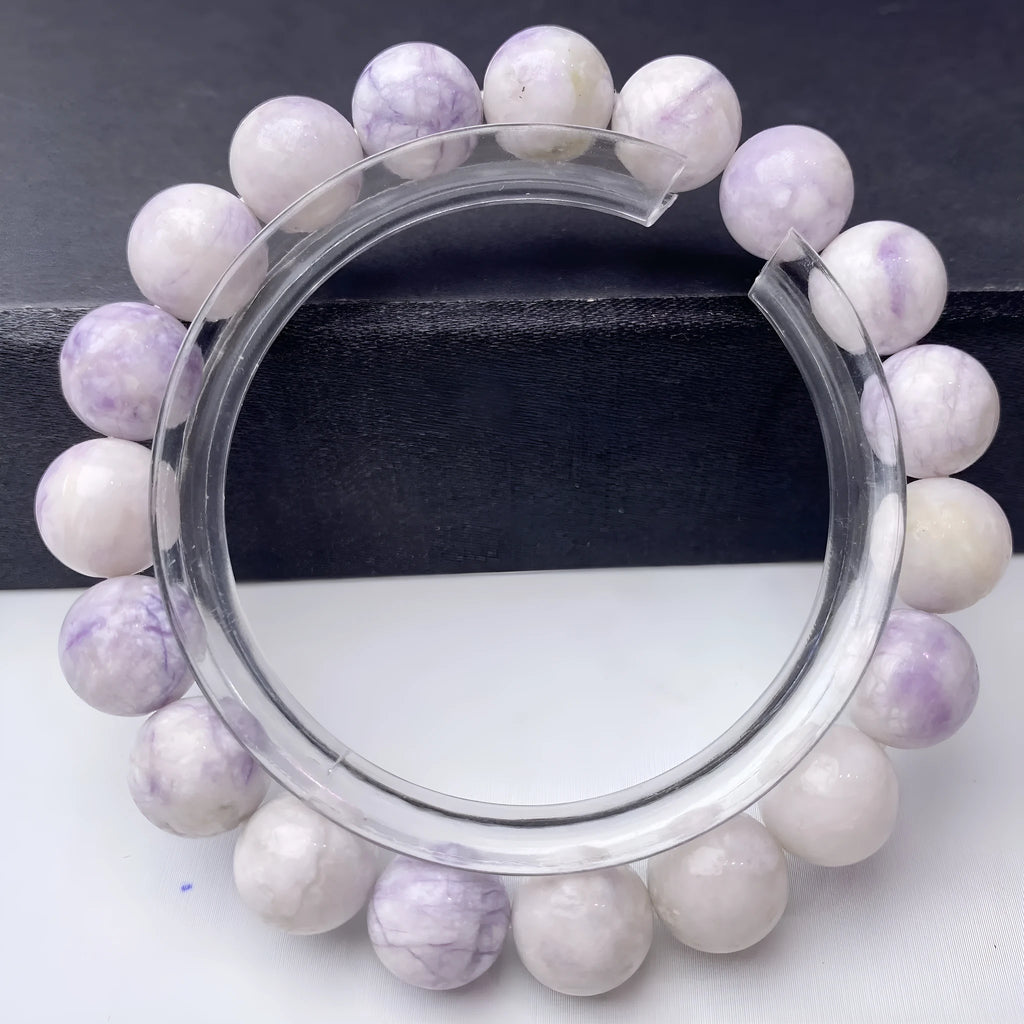 Close-up of a natural purple turquoise beaded bracelet with an adjustable string fastening.