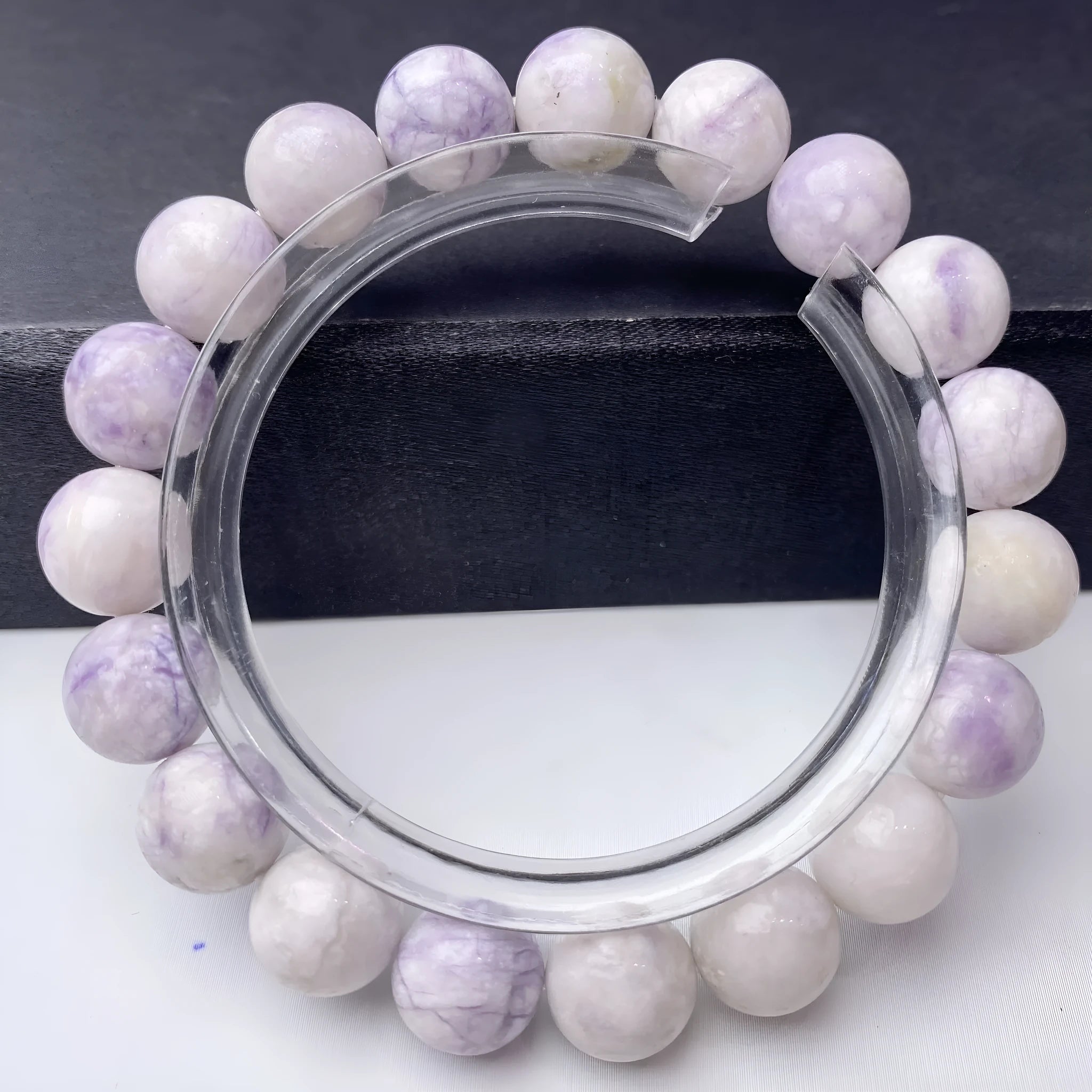Close-up of a natural purple turquoise beaded bracelet with an adjustable string fastening.