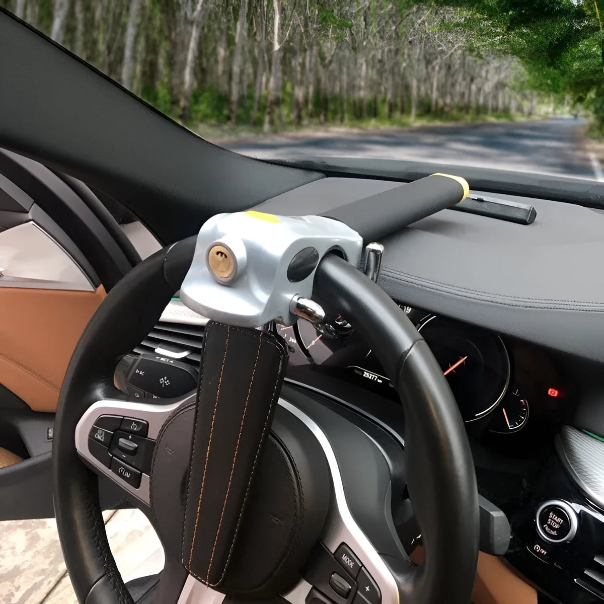 Universal car steering wheel lock in black gold, steel and aluminium alloy with copper core alarm, includes keys and wrench