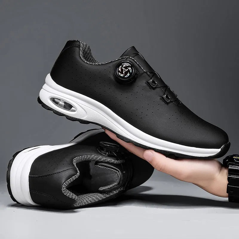 Black and white low-top tennis shoes with mesh upper and composite sole.