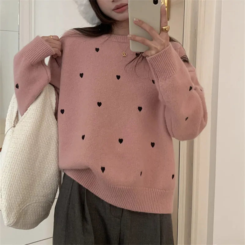 Women's loose grey acrylic pullover sweater with embroidery on the chest.