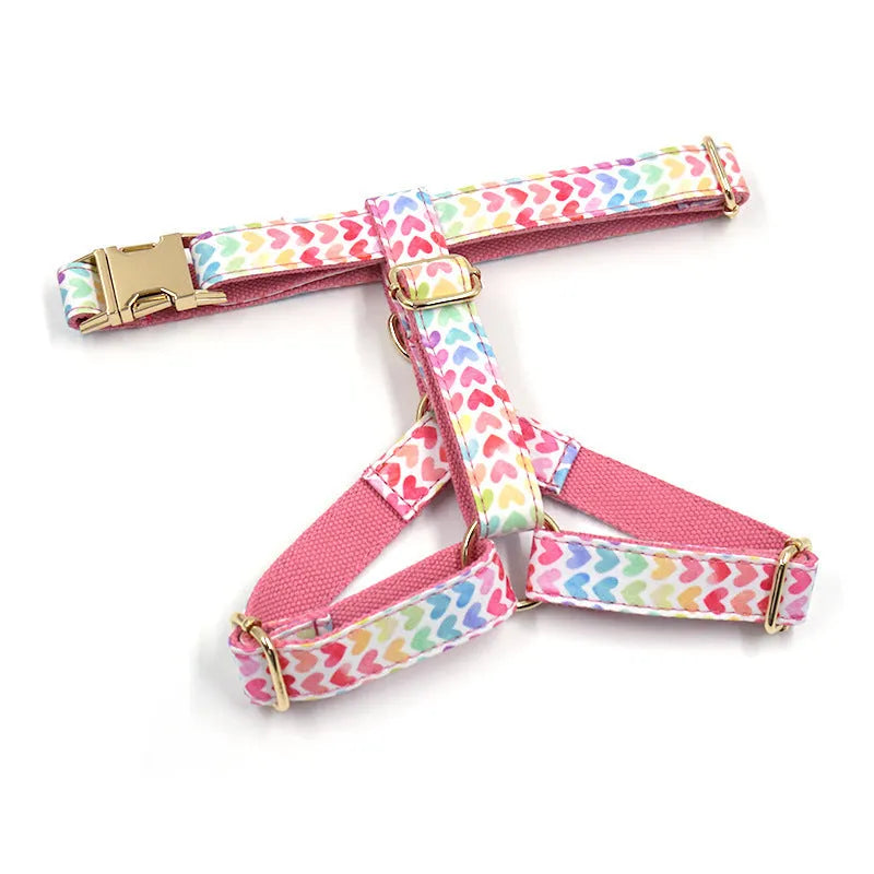 Pink dog harness with gold buckle and colourful heart-shaped stone decoration in four adjustable sizes