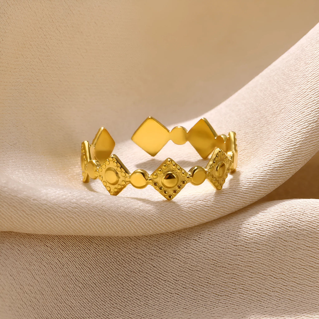 Geometric titanium steel women's ring with gold diamond accents on finger